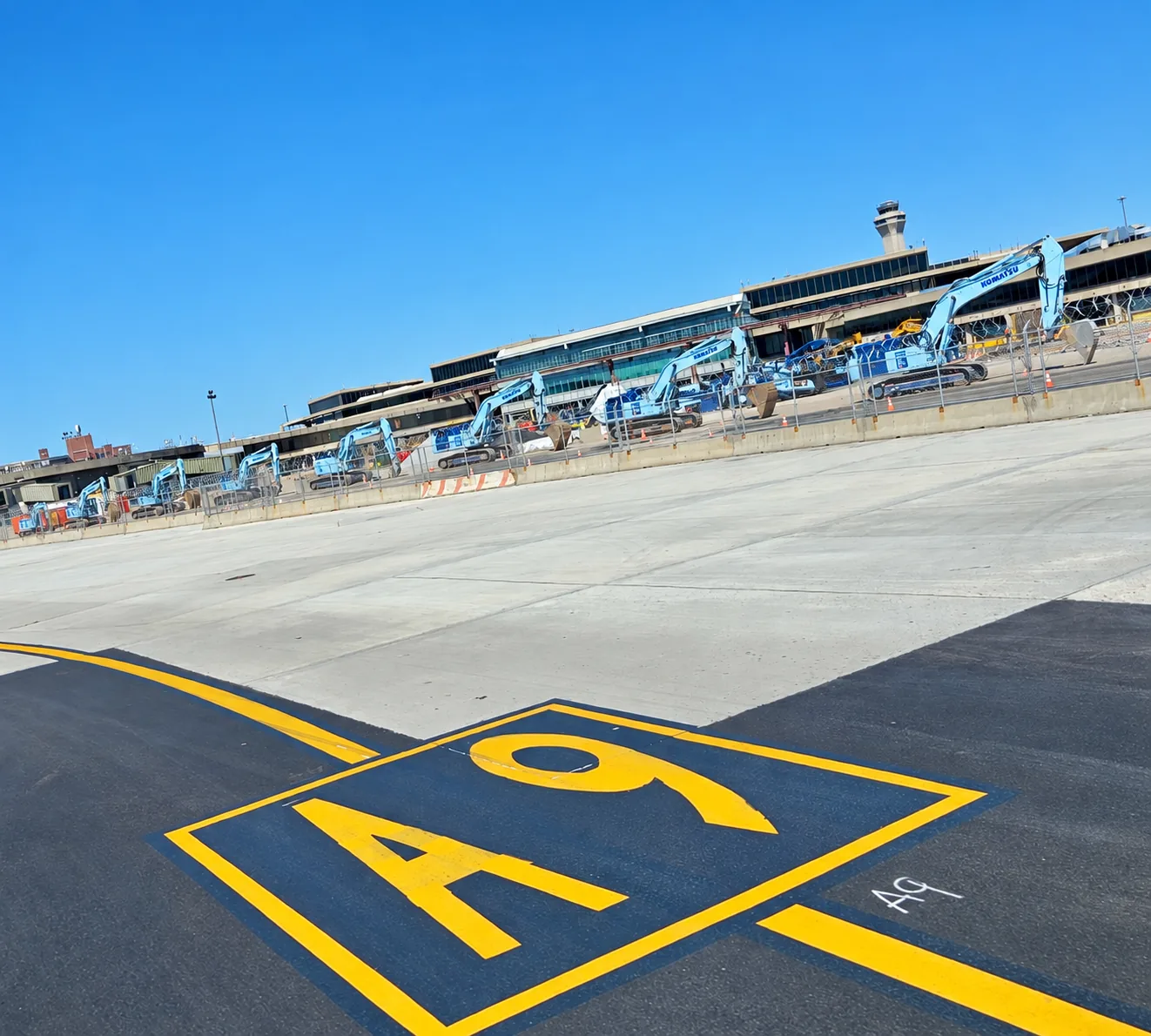 Airfield pavement and construction equipment at an active airport project.
